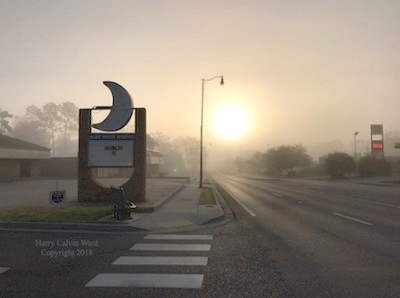 Sunrise against a street light