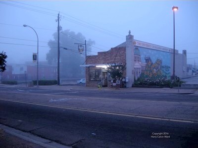 A small, single building on a foggy morning