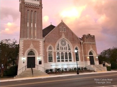 A downtown church with lights at night